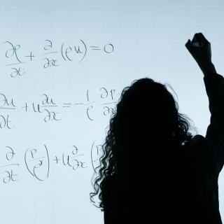 Person writing math formulas Person writing math formulas